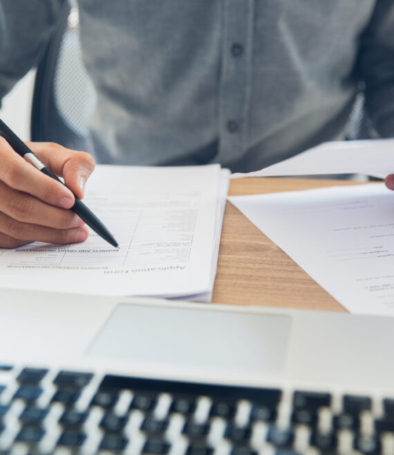 Businessman checking documents at table