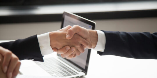 Businessman handshaking businesswoman showing respect, closeup v
