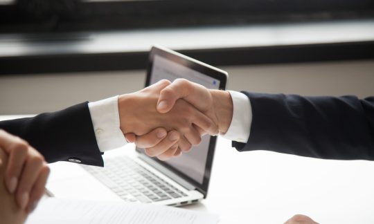 Businessman handshaking businesswoman showing respect, closeup v