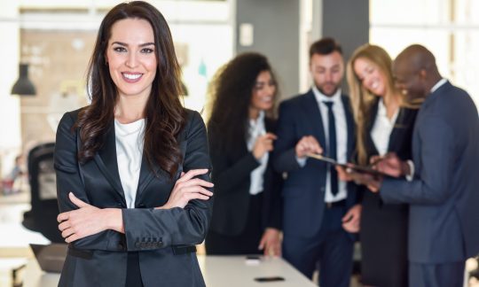 Businesswoman leader in modern office with businesspeople workin